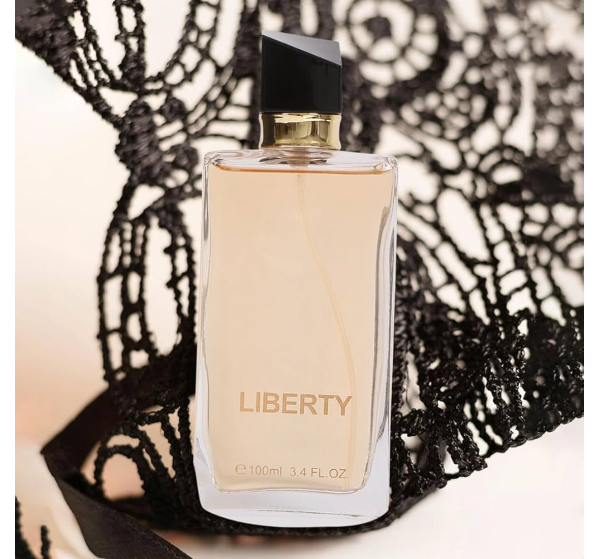 Perfume bottle labeled 'Liberty' on a lace background