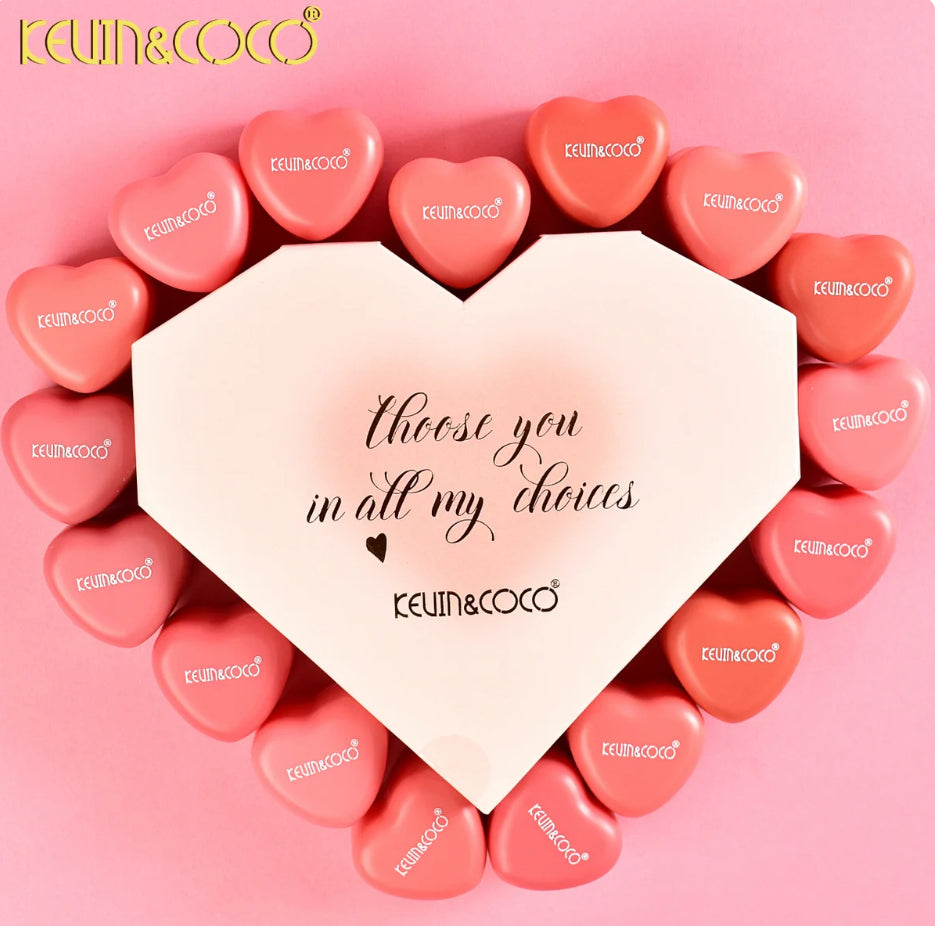 Heart-shaped box with 'I choose you in all my choices' text surrounded by pink heart-shaped lip and cheek colors on a pink background, featuring the brand 'Kevin & Coco'.