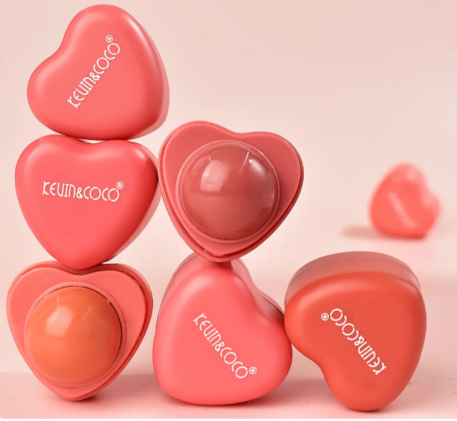 Heart-shaped lip and cheek colors with KEVIN&COCO branding on a pink background