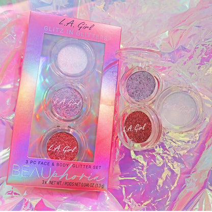 L.A. Girl glitter set with packaging on a colorful background