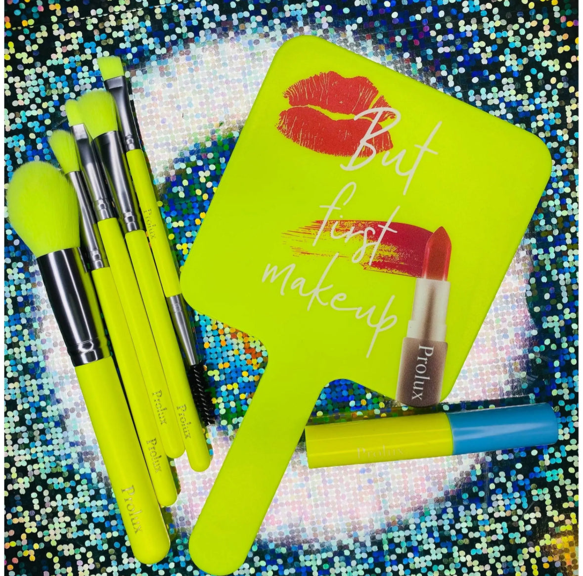 Makeup brushes and a mirror with 'But first makeup' text on a glittery background