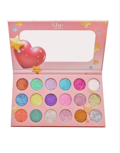 Colorful eyeshadow palette with 'She' branding on a white background