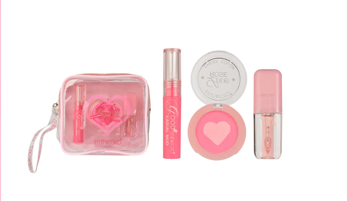 Set of pink makeup products including a pouch, lip gloss, and blush on a white background