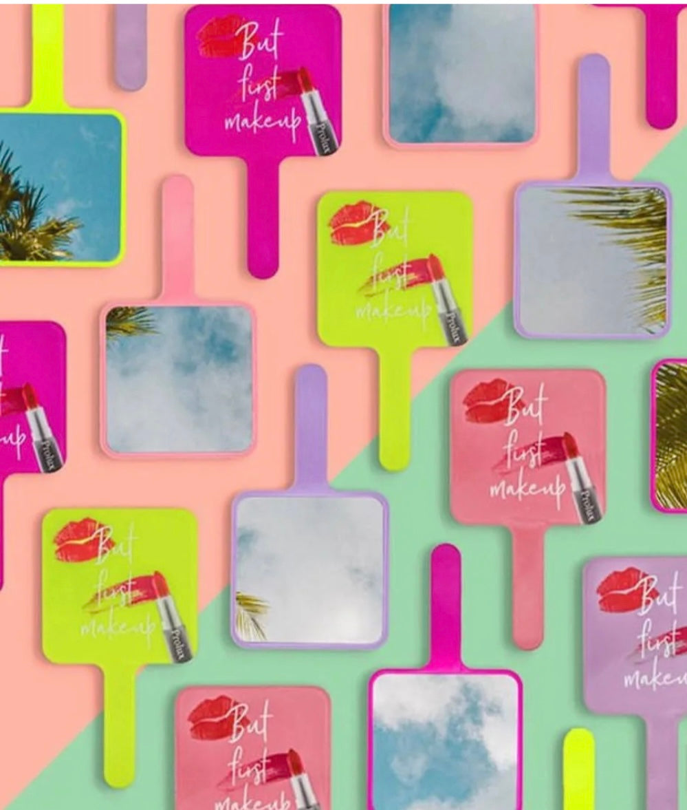 Colorful makeup mirrors with lipstick and text design on a patterned background