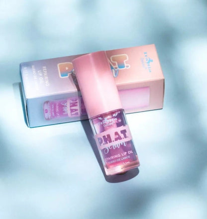 Pink lip oil with 'P.H.A.T. Party' branding on a light blue background